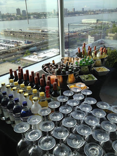 a table with many glasses and bottles of alcohol