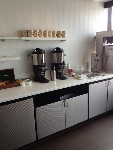 a kitchen counter with coffee machines and coffee maker