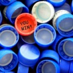a pile of blue plastic caps with a red cap