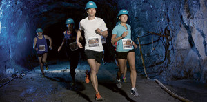 a group of people running in a cave