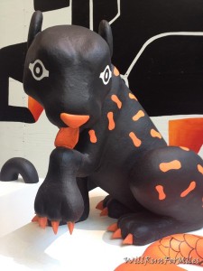 a black and orange lizard statue