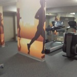 a wall with running images in a gym