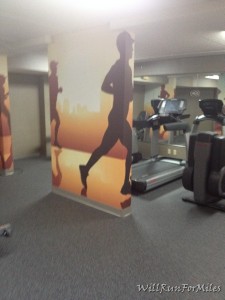 a wall with running images in a gym