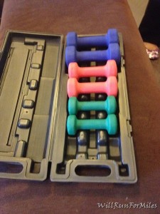 a set of colorful dumbbells in a plastic case