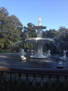 a fountain with statues in the middle of a park