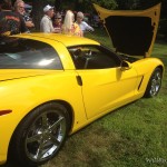 a yellow sports car with its hood up