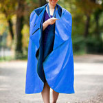 a woman wearing a blue cape