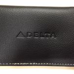 a black leather wallet with white stitching