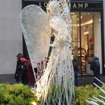 a white angel statue with lights