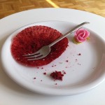 a fork on a plate with a red cake wrapper