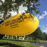 a large yellow balloon with black text with Big Banana in the background