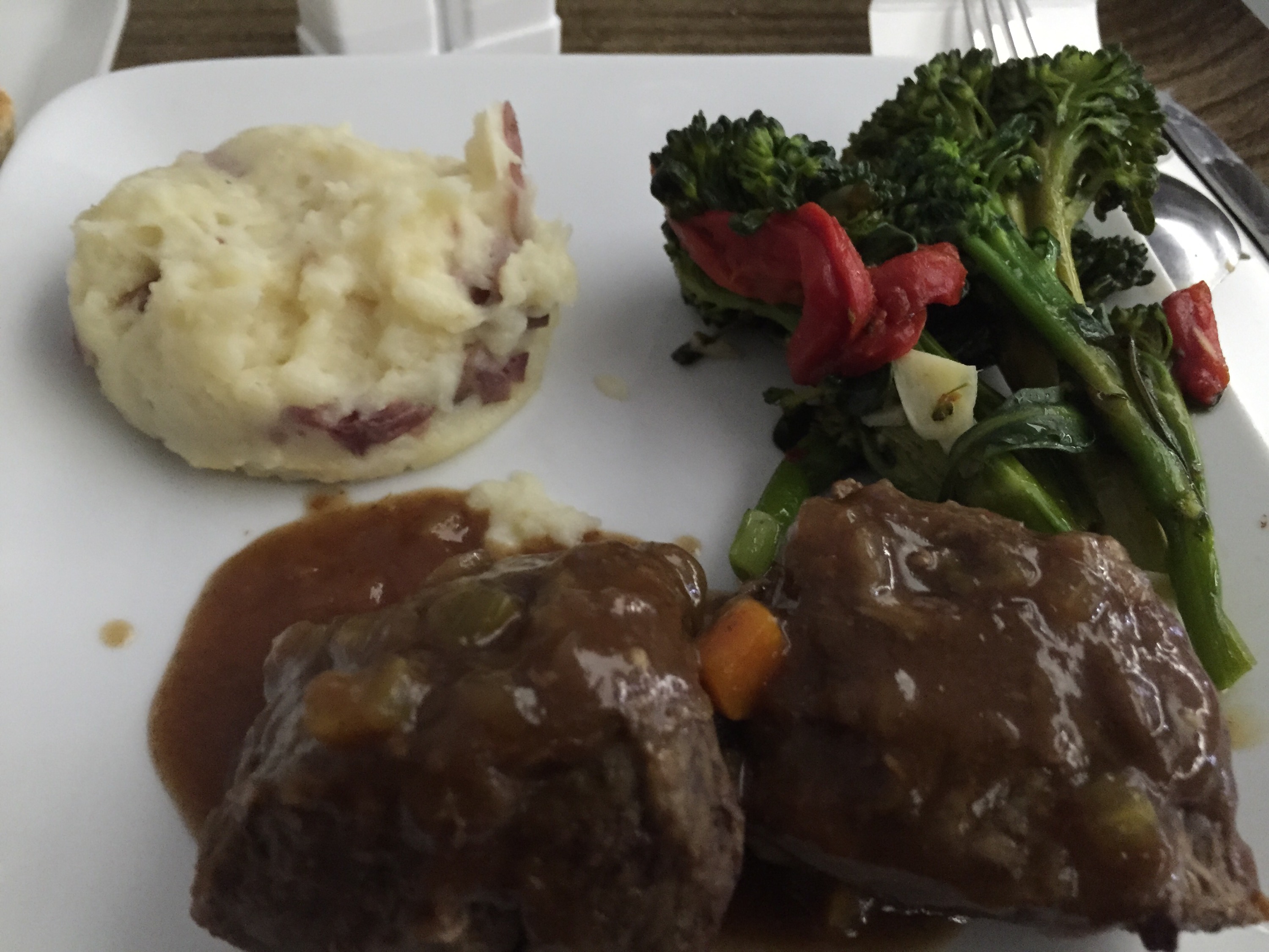 a plate of food with broccoli and mashed potatoes