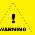 a yellow warning sign with black text