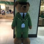a stuffed bear wearing a uniform
