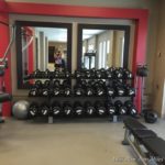 a mirror with a mirror and a rack of weights