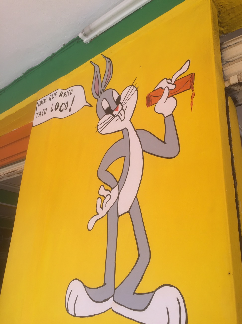 a cartoon rabbit on a yellow wall