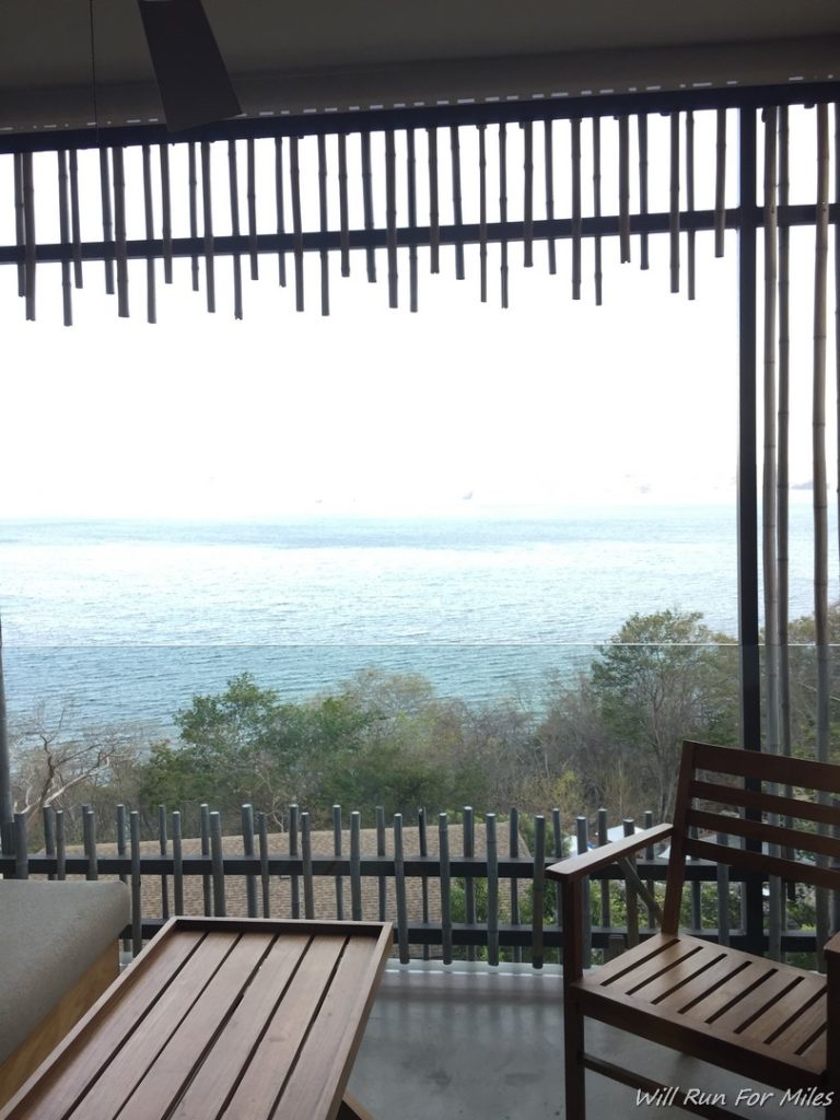 a view of the ocean from a room with a window