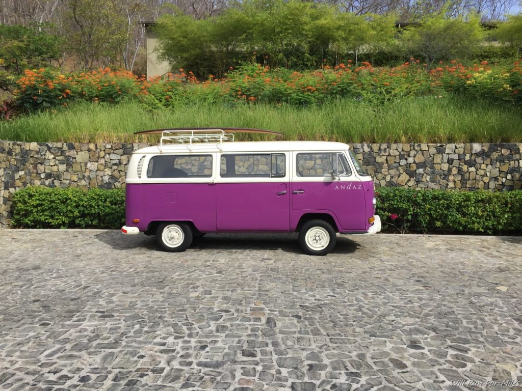 a purple van parked on a stone road