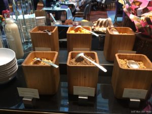 a group of wooden containers with spoons in them