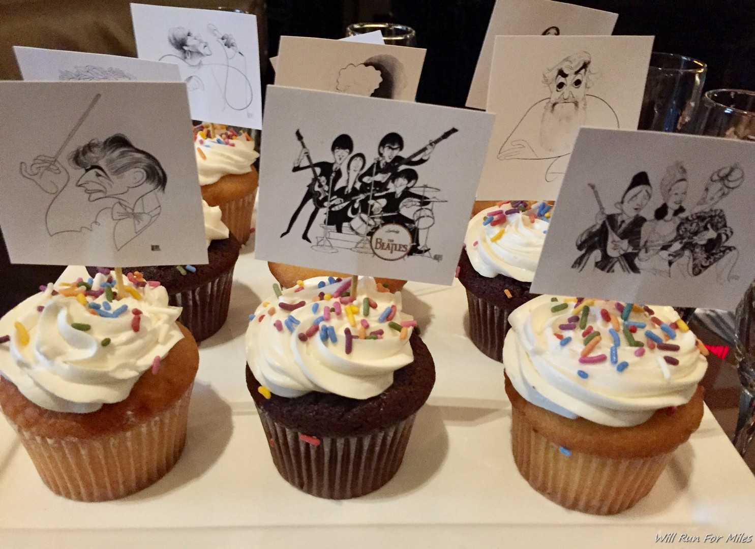 a group of cupcakes with a drawing of a band