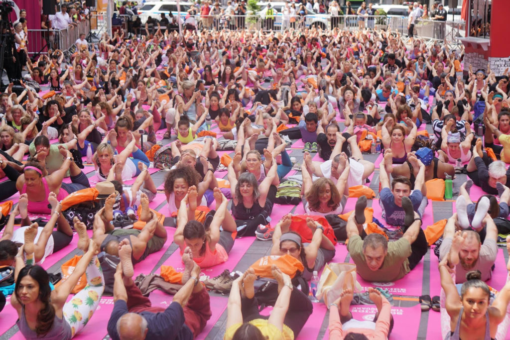 a large group of people doing yoga
