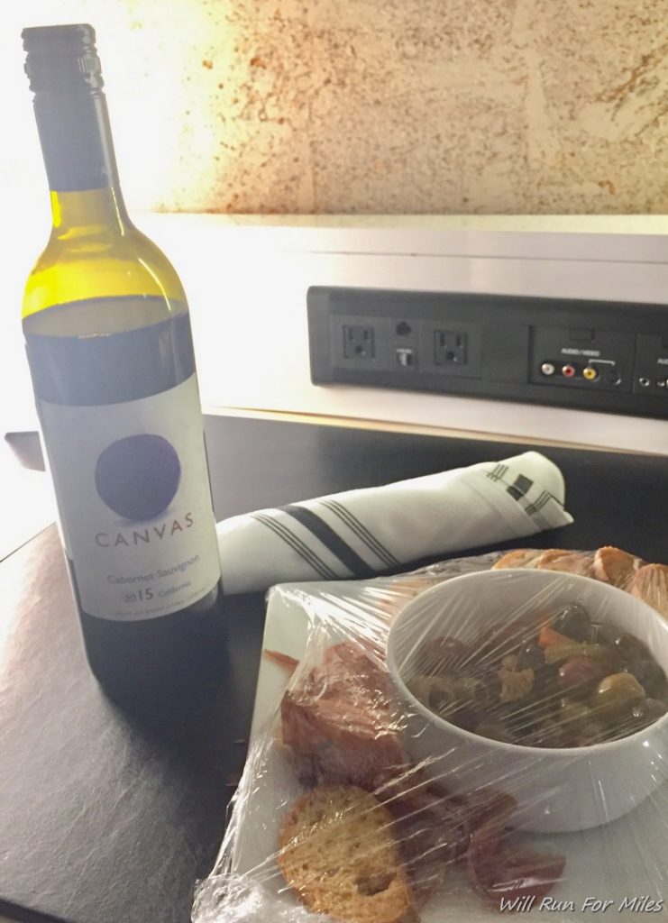 a bottle of wine next to a bowl of food