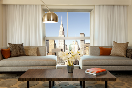 a living room with a large window and a large city view
