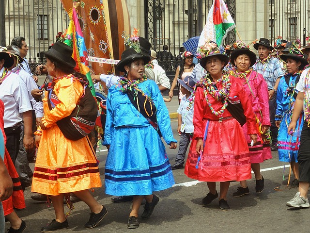 a group of women in colorful dresses walking down the street