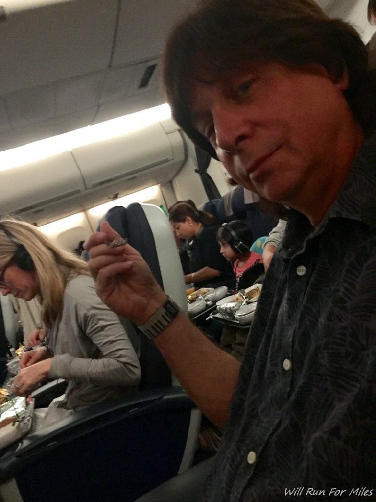 a man eating in an airplane