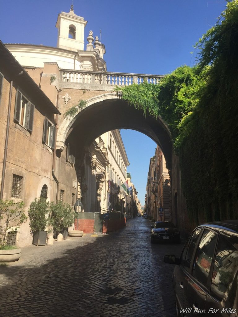 a stone street with a stone arch over it