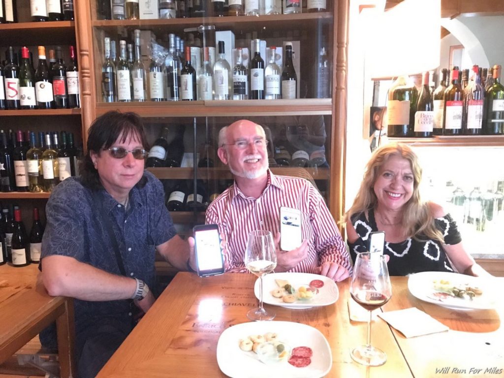 a group of people sitting at a table with food and drinks