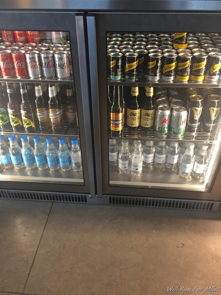a refrigerator with cans of beer and bottles
