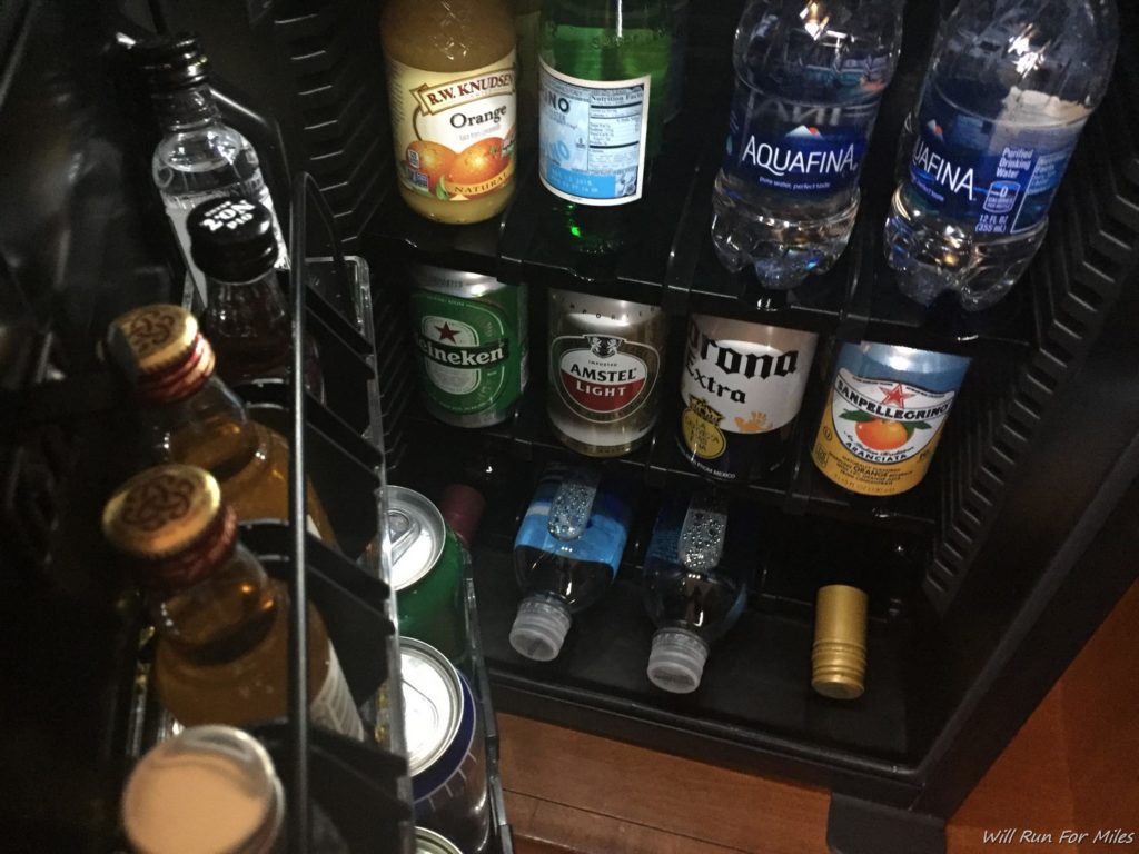 a shelf of bottles and cans of alcohol