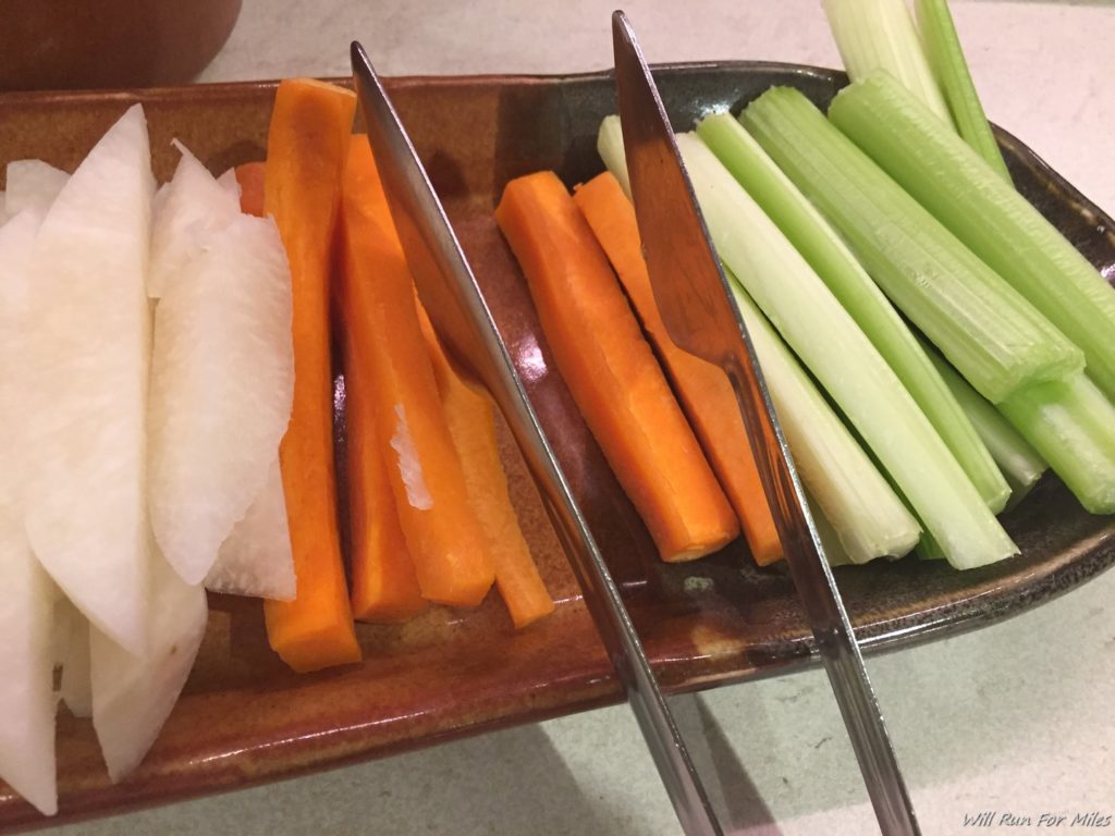 a plate of vegetables with knives