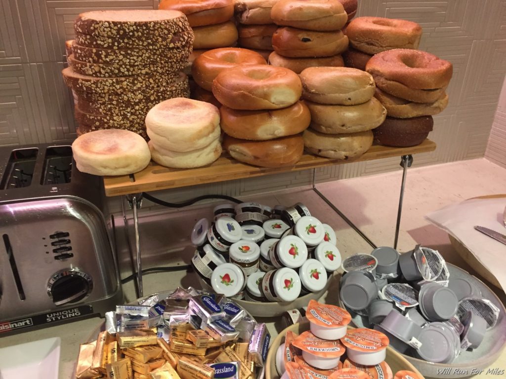 a shelf with different types of bagels and other items