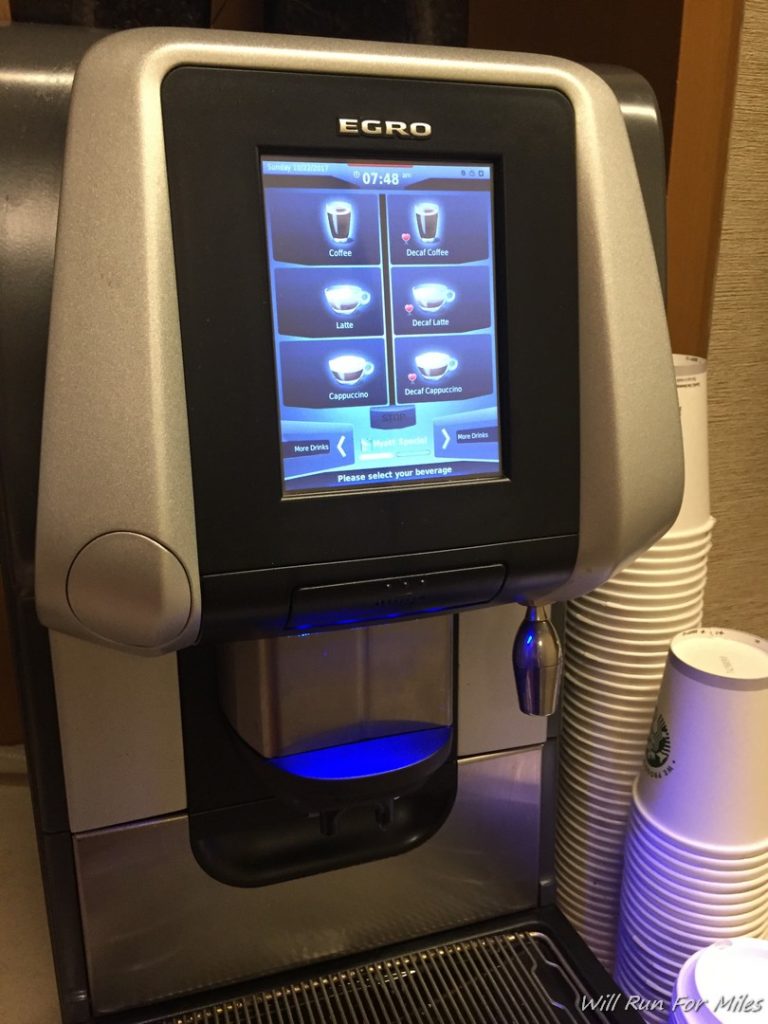 a machine with a screen and cups