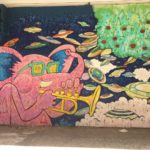 a mural of a pink animal playing a trumpet