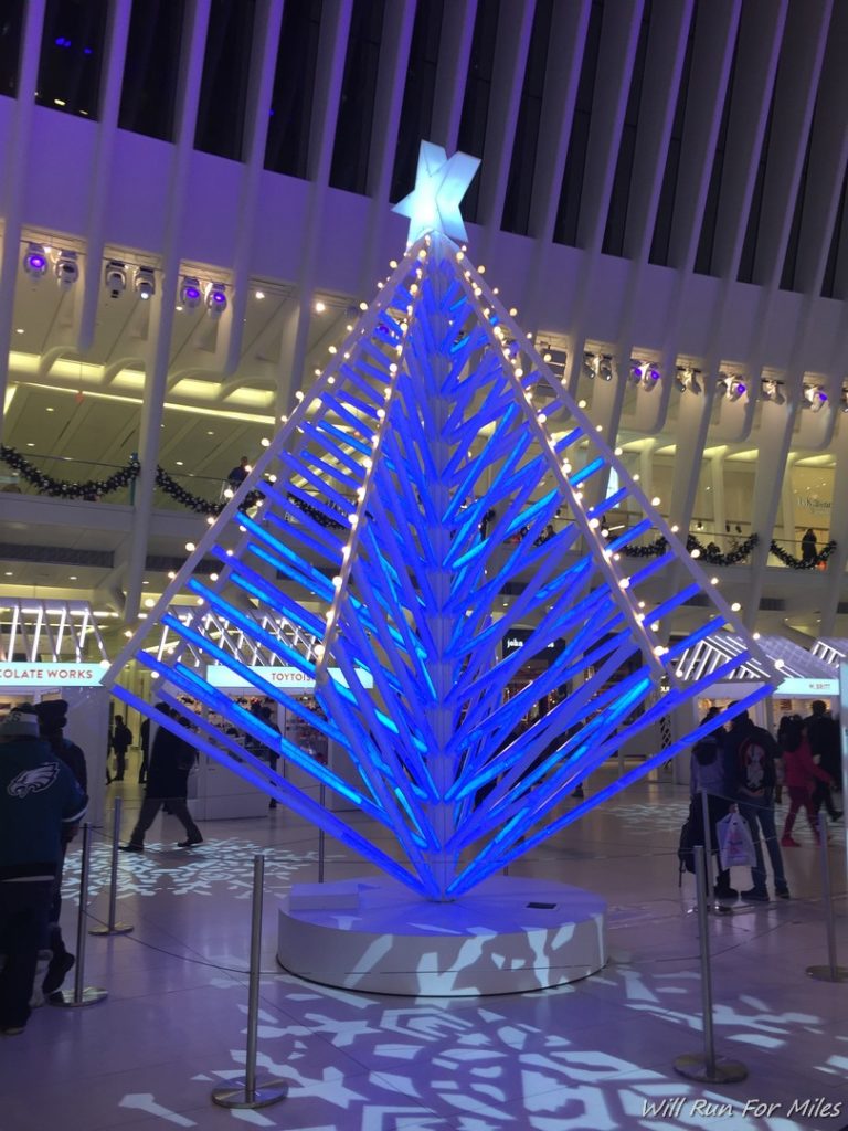 a blue christmas tree in a building