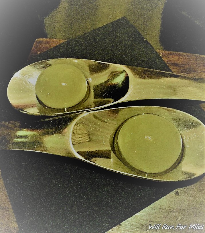 a pair of metal spoons with candles