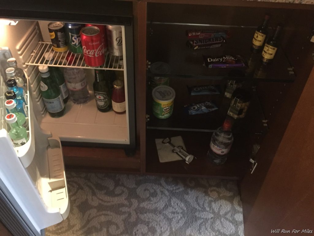 a mini fridge with drinks and candy