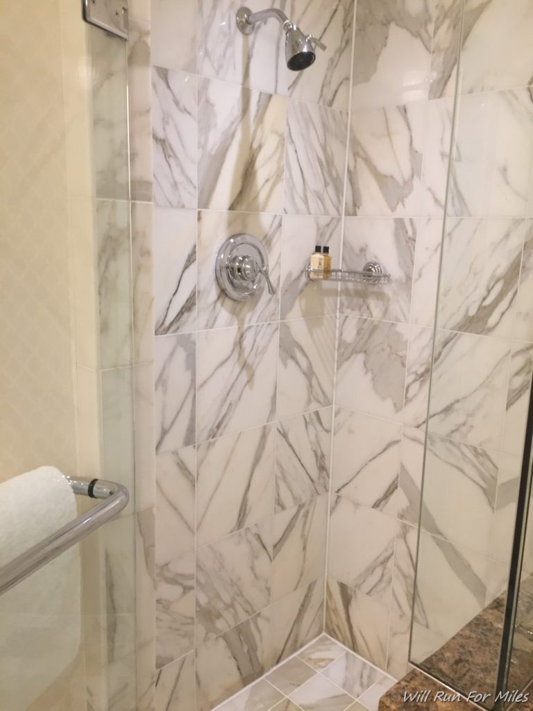 a shower with marble tiles