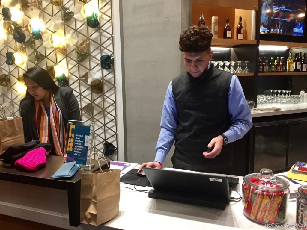 a man standing at a counter with a laptop