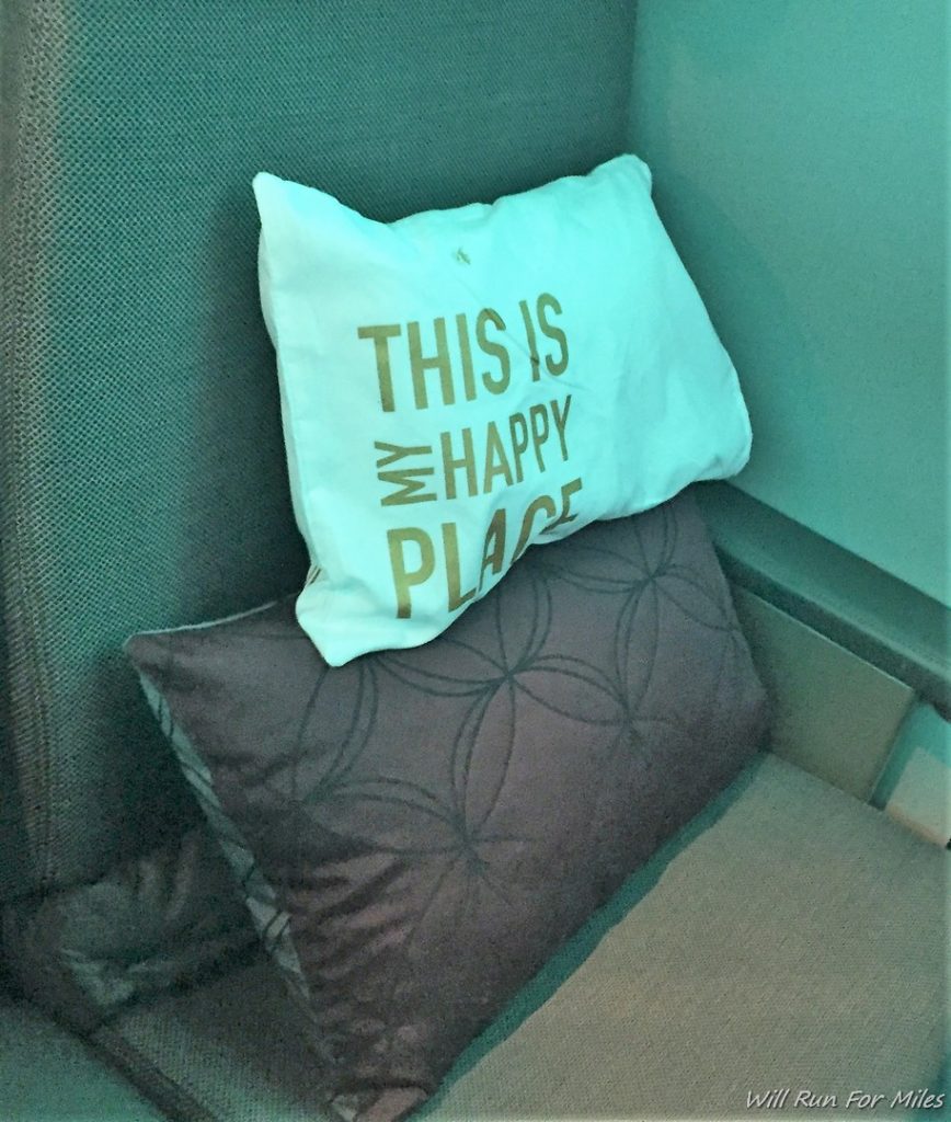 a white pillow on a brown pillow