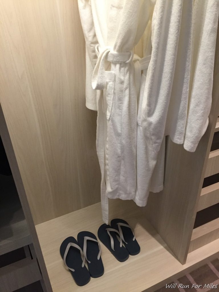 a white robe and flip flops in a closet