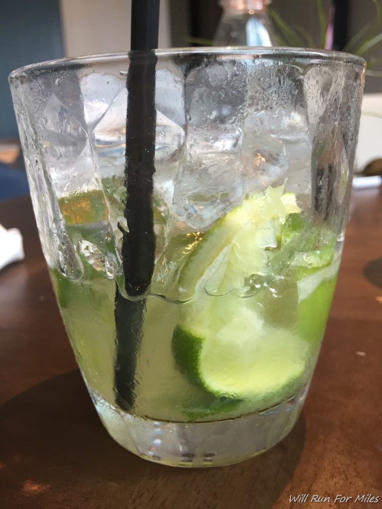 a glass with ice and limes