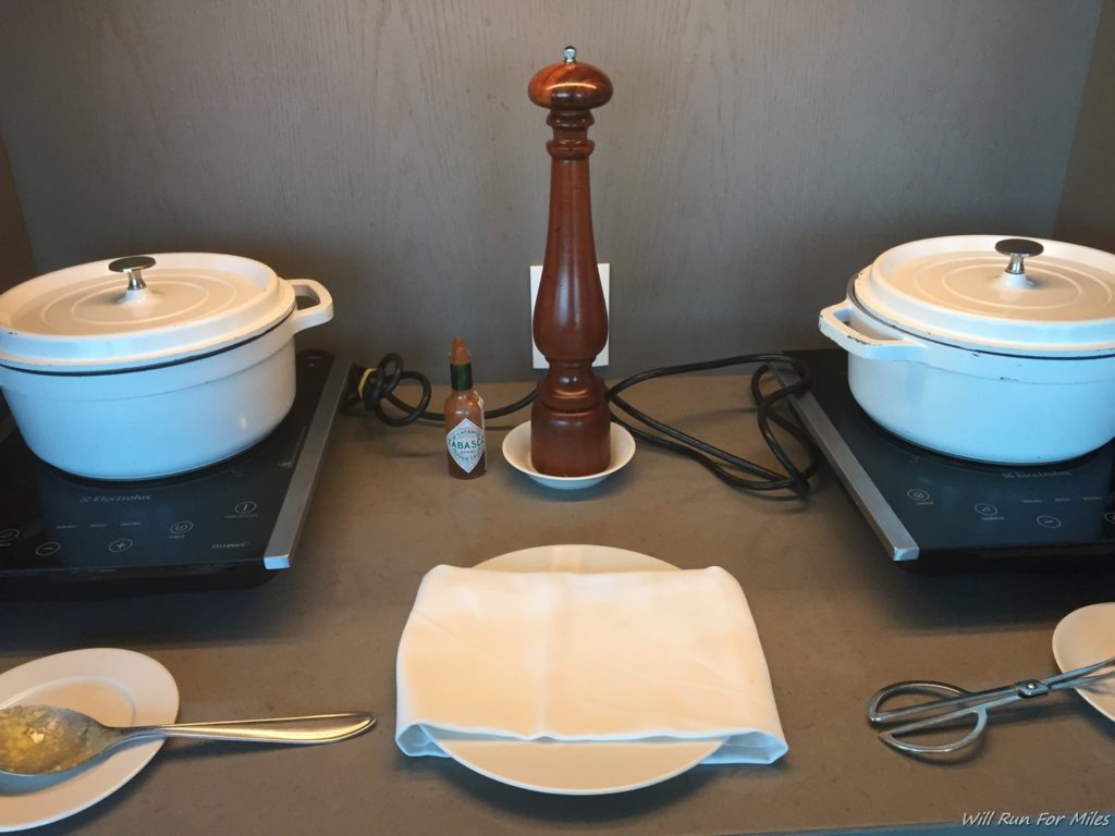 a table with white pots and saucers