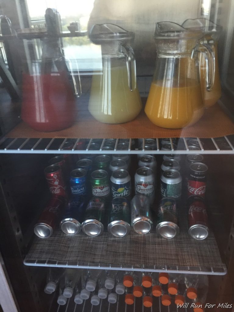a glass shelf with drinks and cans