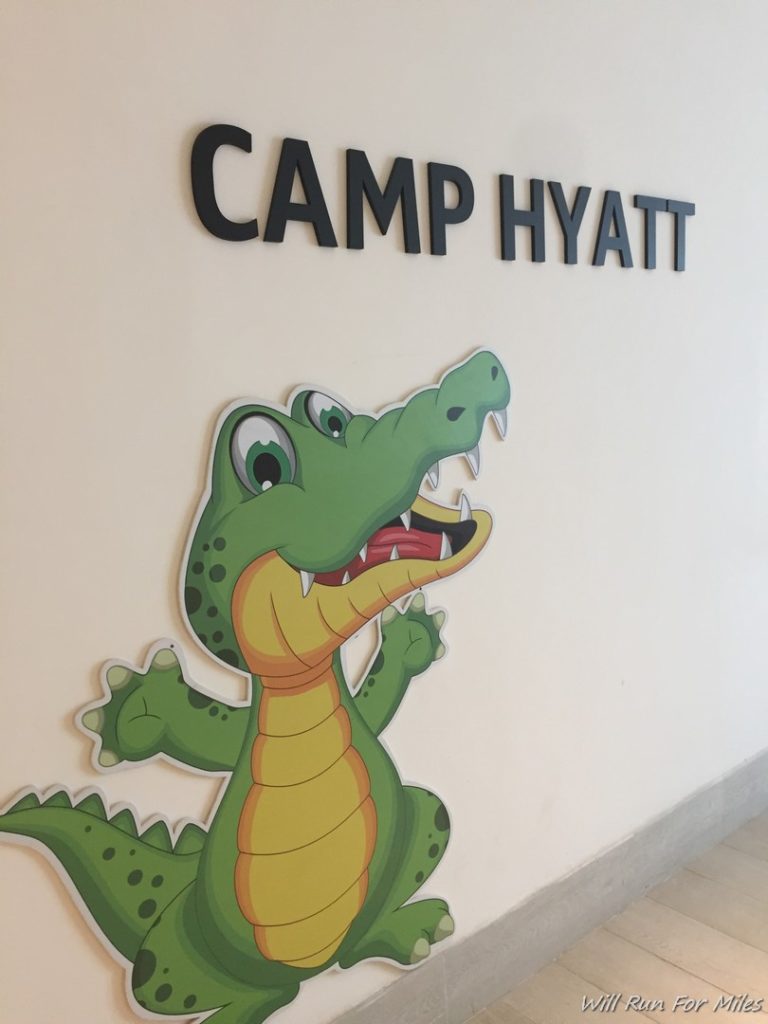 a cartoon alligator on a wall