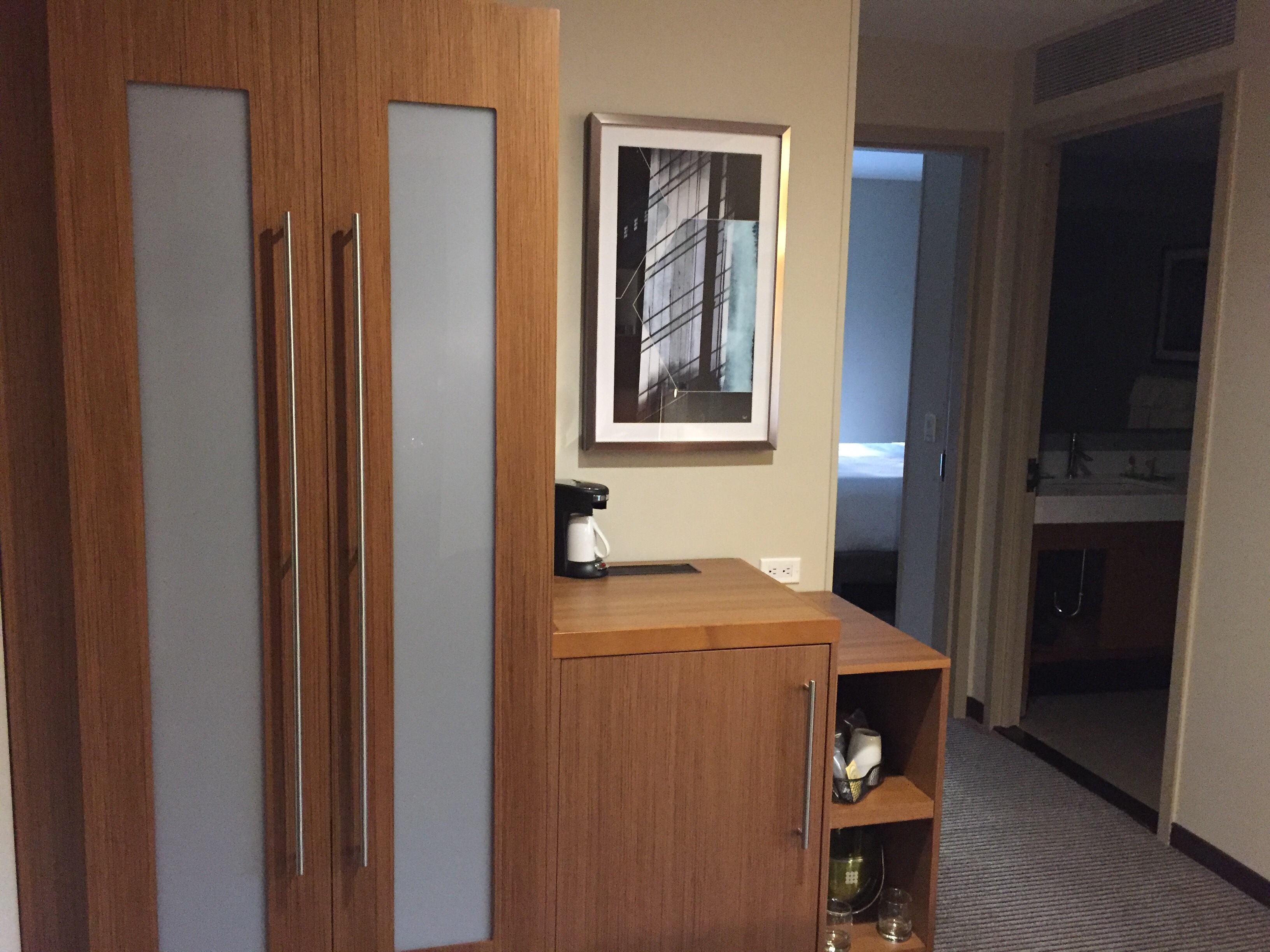 a room with a cabinet and a coffee maker