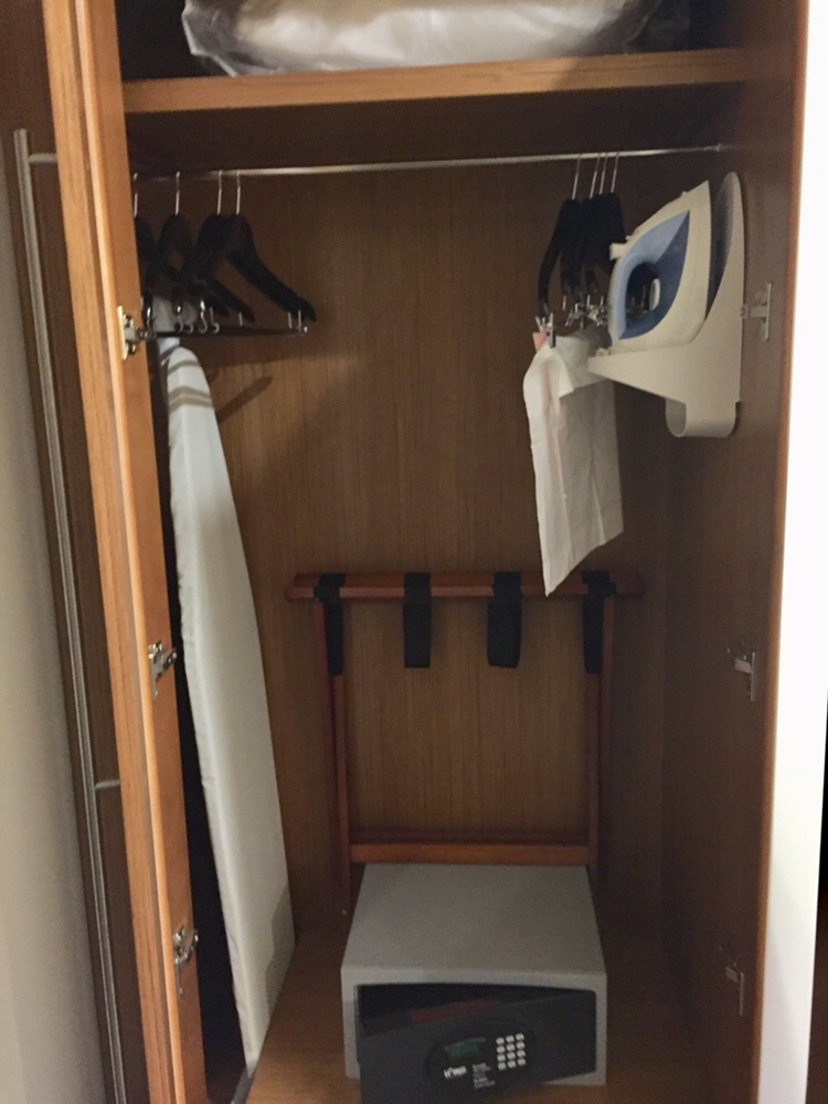 a closet with clothes on swingers
